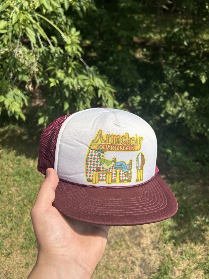 A vintage foam-front trucker hat with an 'armchair quarterback' football gag — peak 80s tailgate energy and actually wearable.