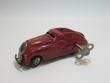 SCHUCO KOMMANDO ANNO 2000 MAROON COLOUR TINPLTE CLOCKWORK CAR