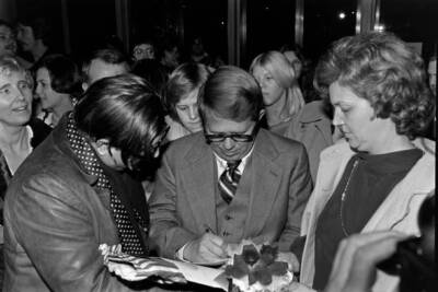 Billy Carter signs autographs during a party at the Kennedy C- 1977 Old Photo