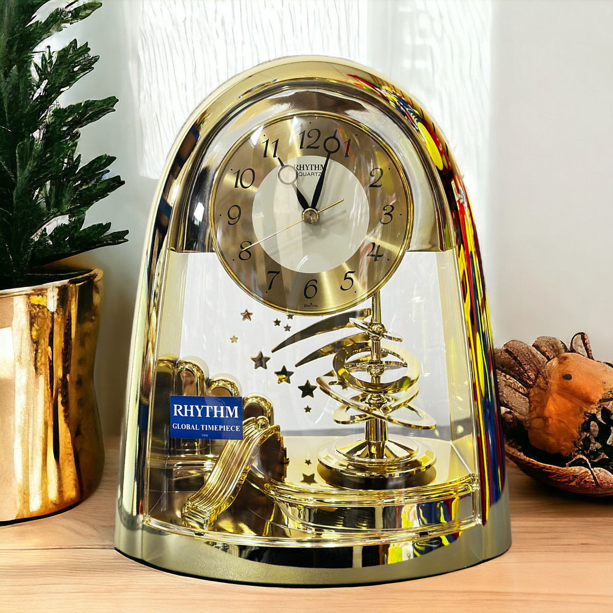 Rhythm Mantel Clock Gold with Rotating Pendulum and Shooting Stars  