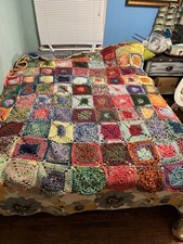 Quilt colorful, handmade, crocheted granny square blanket.