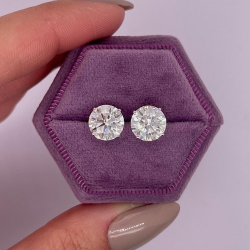 Gia diamond stud earrings with round cut CVD 6.24 Ct, held in a purple velvet jewelry box with clear lid.