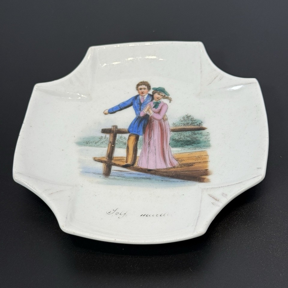 A hand-painted antique porcelain dish shaped like a draped handkerchief with a comedy face — surreal, sculptural, and conversation-starting in the best way.