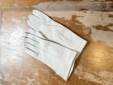 pair of vintage white leather gloves, possibly made of kidskin or calfskin.