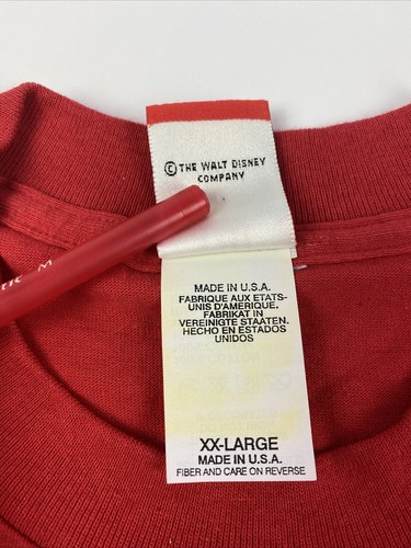 Red vintage Disneyland Mickey Mouse T-shirt with white tag reading “The Walt Disney Company Made in U.S.A.”