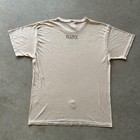 Tan vintage 80s military stencil shirt with blue back graphic reading “MARX” in bold block letters.