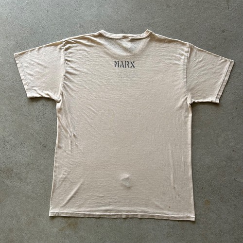 Tan vintage 80s military stencil shirt with blue back graphic reading “MARX” in bold block letters.