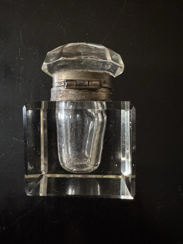 A hand-cut crystal Victorian inkwell with a hinged brass lid — beautiful as a desk object even if you never dip a pen in it.