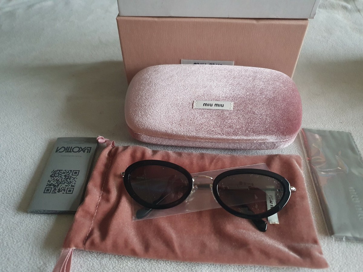 Miu Miu black / silver frame cat's eye sunglasses. SMU 58U 1AB-5O0