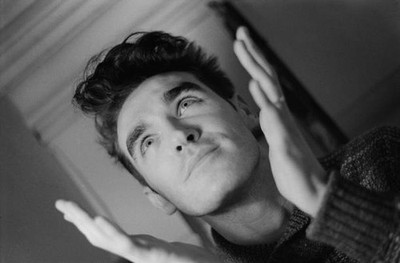 Headshot of British singer Morrissey both hands raised either side- Old Photo