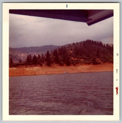 Vtg Color Snapshot Scenic Lake View Forested Hills Shoreline Small Boat 1973