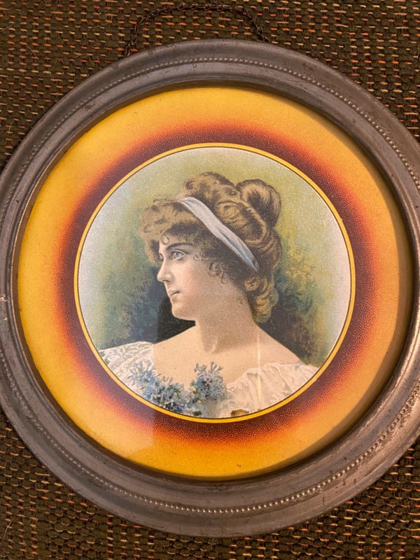 Vintage Victorian-era flue cover featuring a portrait of a debutante.
