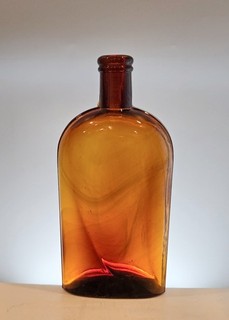 Antique Medium Amber Glass Strap Side Whiskey Flask with Dark Amber Swirls