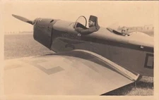 RPPC postcard of Men Sitting in a Vintage Airplane 
