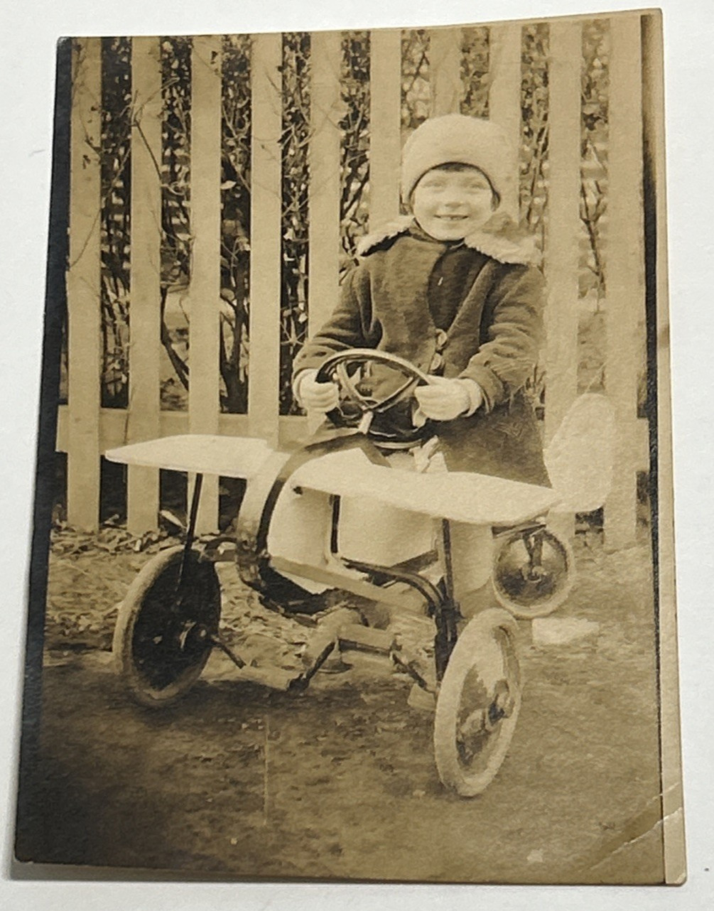 Vintage 30s Sepia Photograph Child On Pedal Tricycle Plane Bike in Winter 3.5x5"