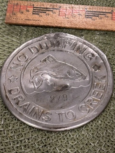 Vintage metal storm drain marker creek