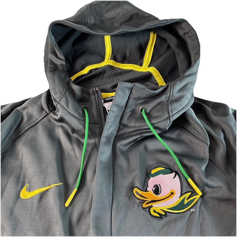 Jaqueta com capuz Nike Oregon Ducks Therma-FIT zíper completo cinza amarelo verde - Imagem 2 de 4
