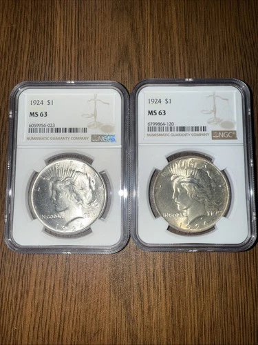 Qty(2) 1924 Peace Dollar coin, graded by (NGC) as MS 63.