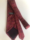 Burgundy silk tie with gold polo shirt and golf clubs, labeled “Polo Ralph Lauren by Ralph Lauren.”