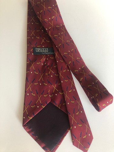 Burgundy silk tie with gold polo shirt and golf clubs, labeled “Polo Ralph Lauren by Ralph Lauren.”