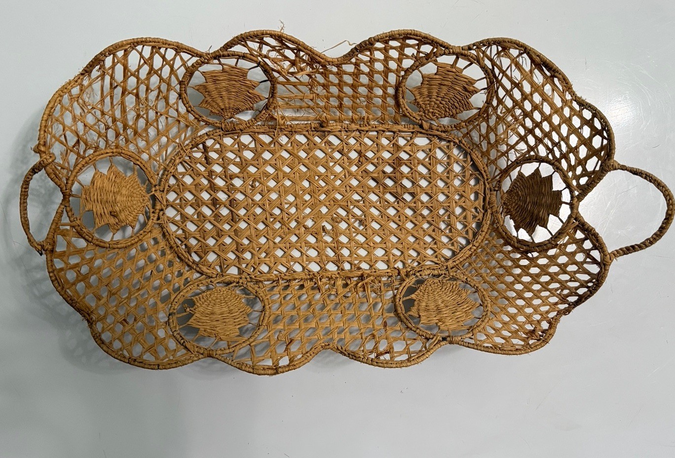Vintage boho rattan wicker serving tray with scalloped openwork leaf design and basket handle