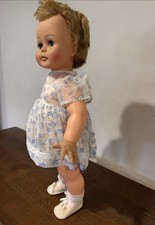 Vintage Baby Doll With Blonde Hair And Floral Dress
