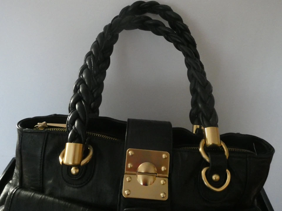 Bolso de hombro Steven by Steve Madden para mujer de cuero genuino negro dorado cierre giratorio Foto 2 de 4