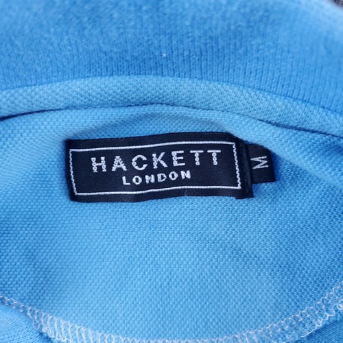 Light blue Hackett London polo shirt tag with black fabric label showing white text and size M.