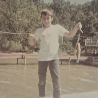 Vintage Color Photo Snapshot of Boy Holding up Small Fish on Dock by Lake