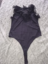 Ladies Black Ribbed Bodysuit With Ruffle Sleeve And Neck Detailing