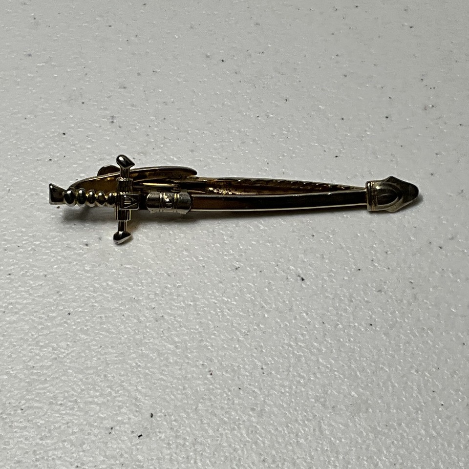 A gold-tone sword/dagger tie bar made in the USA — subtle enough to wear, wild enough to spark a conversation at any formal event.