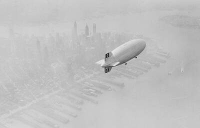 The Hindenburg dirigible flying over the southern tip of Manhattan .. Old Photo