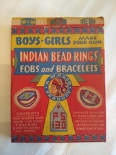 Indian beads kit, 1947, decorative box, some beads and wire in the envelope.