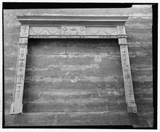 76. FIREPLACE SURROUND. THIS SURROUND WAS FOUND IN THE NORTHEAST BED CHAMBER IN
