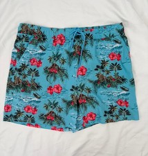 Caribbean Joe blue tropical floral swim trunks feature a palm tree