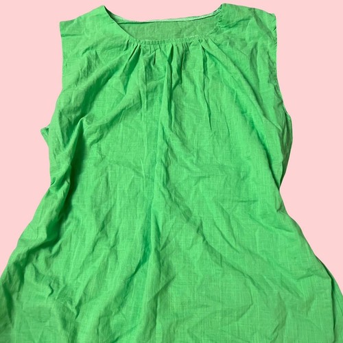 Green sleeveless linen top with gathered detail on the front.