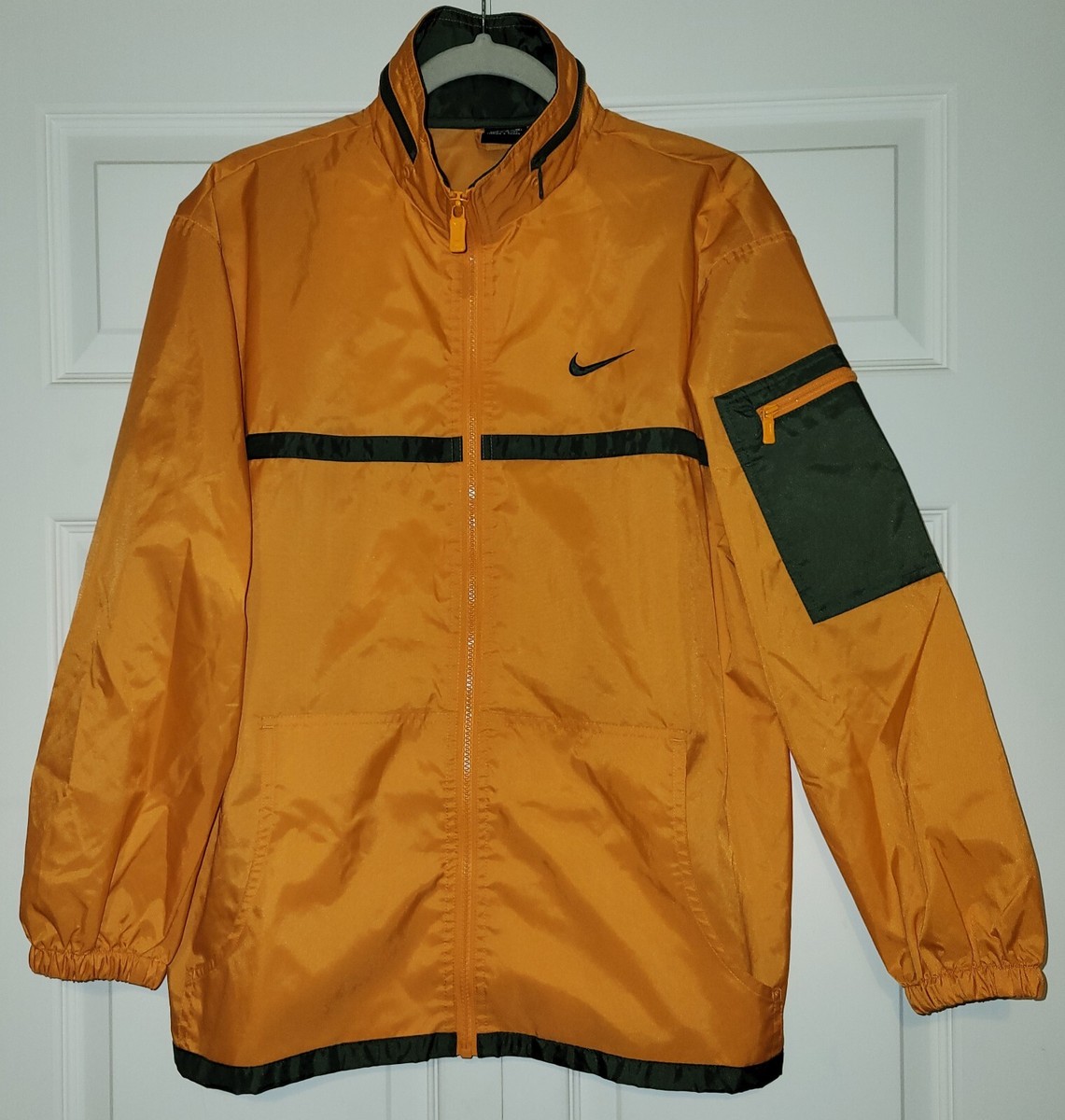 olive green and orange nike jacket