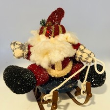 Santa sitting on Metal Sleigh. Fabric Santa. 8 tall
