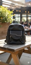 Black studded faux leather backpack with silver accents