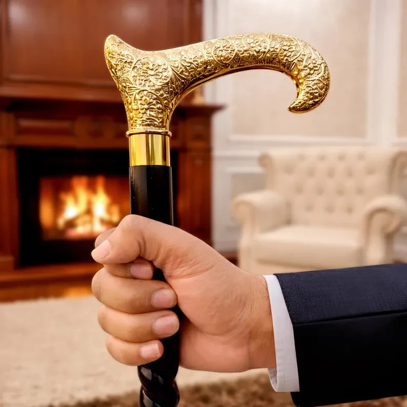 Hand-engraved brass derby handle on a twisted black wood shaft — a genuinely artisan walking cane that doubles as a gentleman's statement piece.