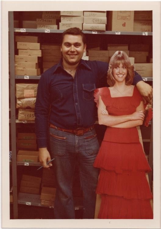 Man with 3/4-scale standup/standee/cardboard cutout of Olivia Newton-John, 1970s
