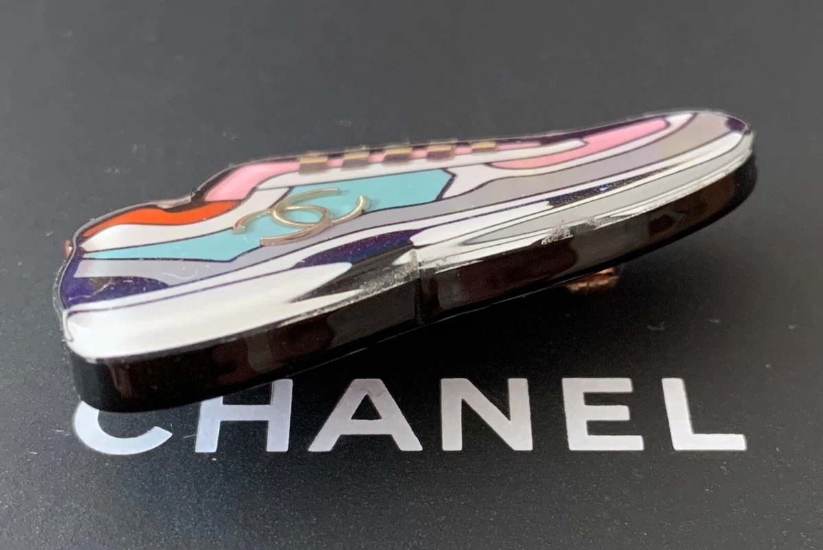 Resin, Enamel and Ruthenium Metal Pin brooch featuring polish coloured  beads and a silver chain charm with classic Chanel logo pendents. Chanel.  2012., Handbags and Accessories Online, Ecommerce Retail