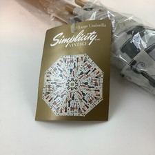 Simplicity Vintage Style Umbrella Covered With Patterns And Sewing Accessories.