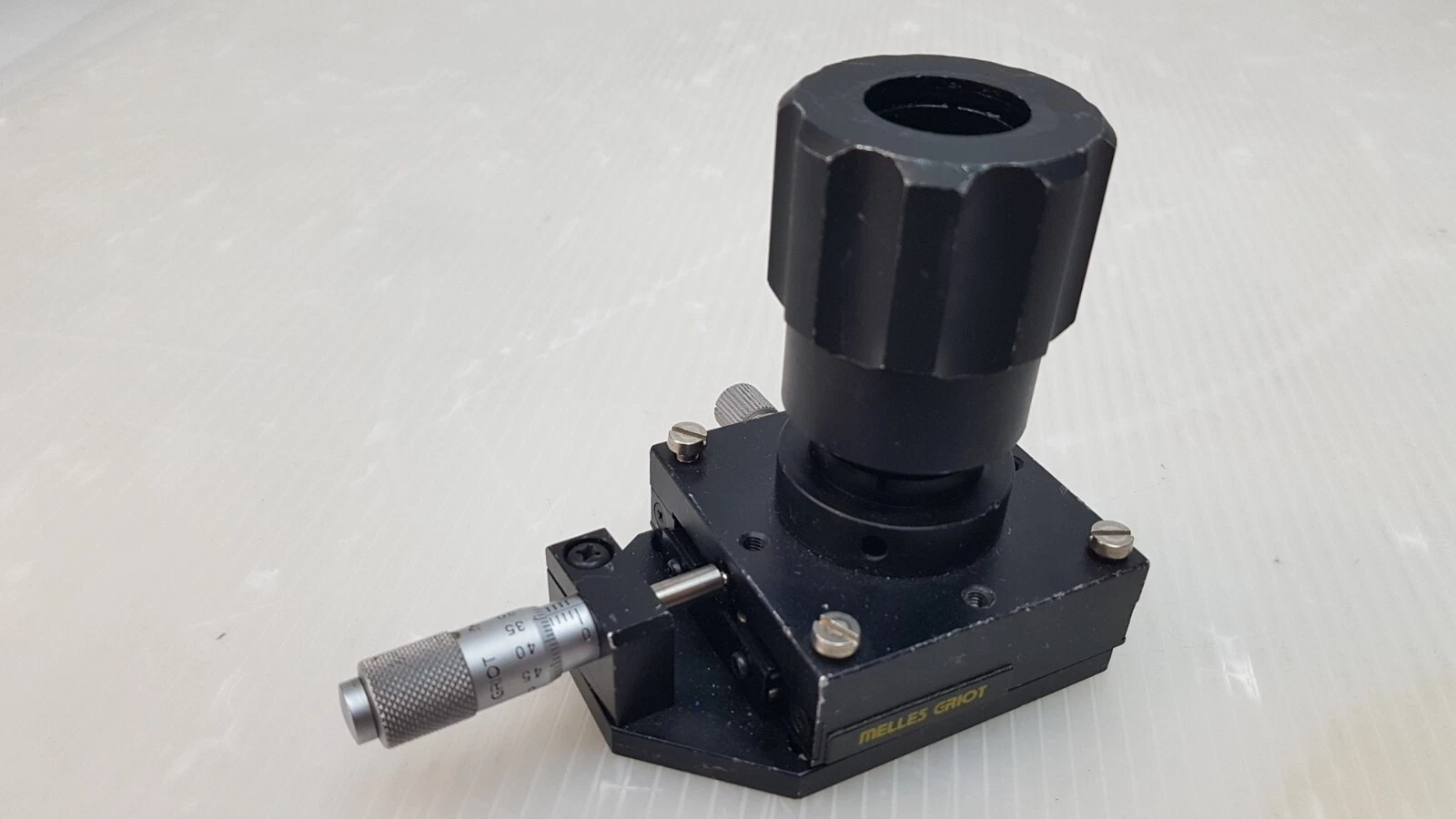 Angled view of the Melles Griot translation stage with name plate and micrometer