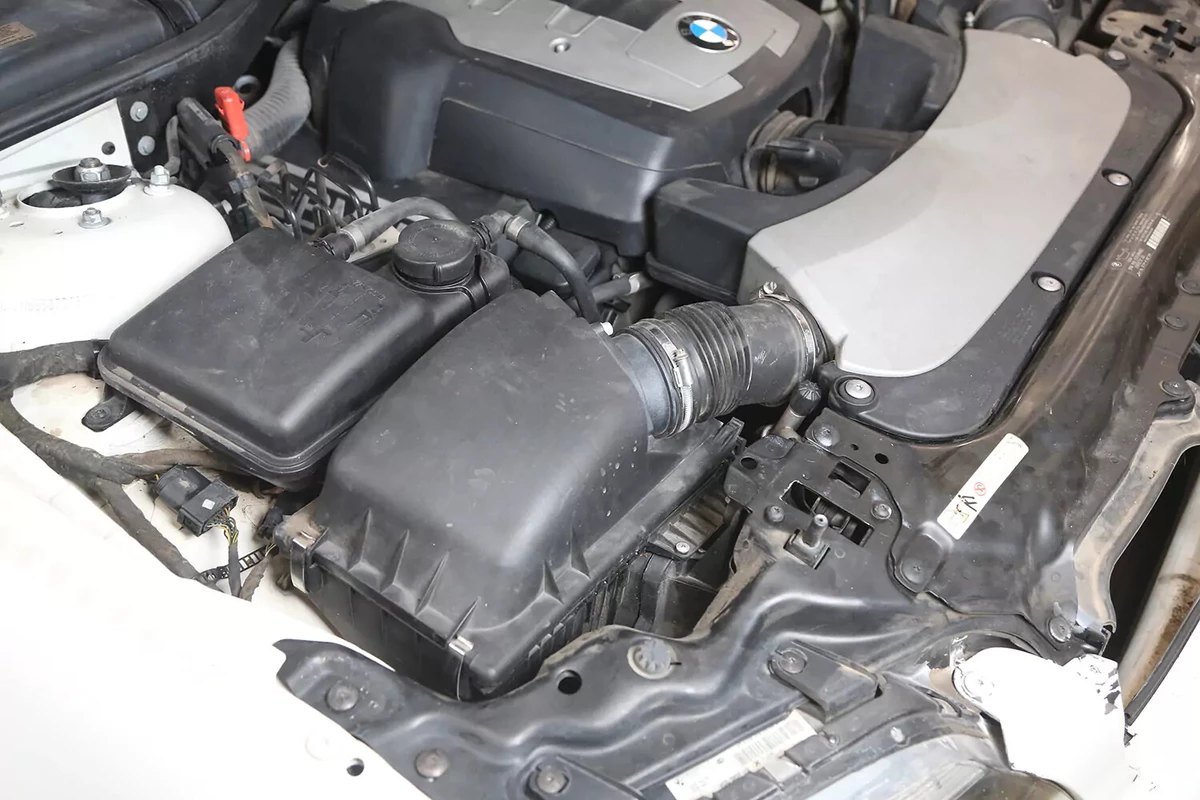 The large black plastic housing which holds the vehicle's engine air filter.