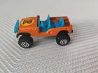 vintage 1980s orange Corgi Juniors 4x4 Jeep with blue interior and large black