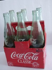 Six vintage coca cola bottles