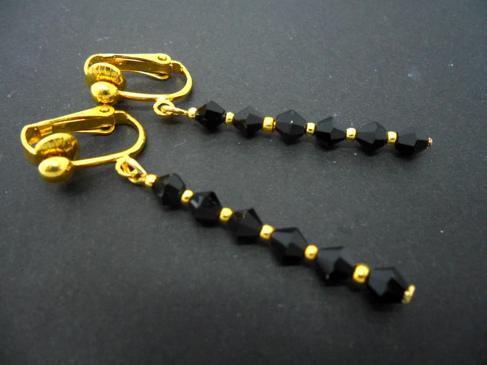 A PAIR OF BLACK CRYSTAL GLASS BEAD GOLD PLATED CLIP ON DROP EARRINGS. NEW. - Image 1 of 1