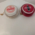 Lot of 2 Vintage Coca-Cola Yo-Yos - 1970s Red Wood & 1990s Clear Plastic