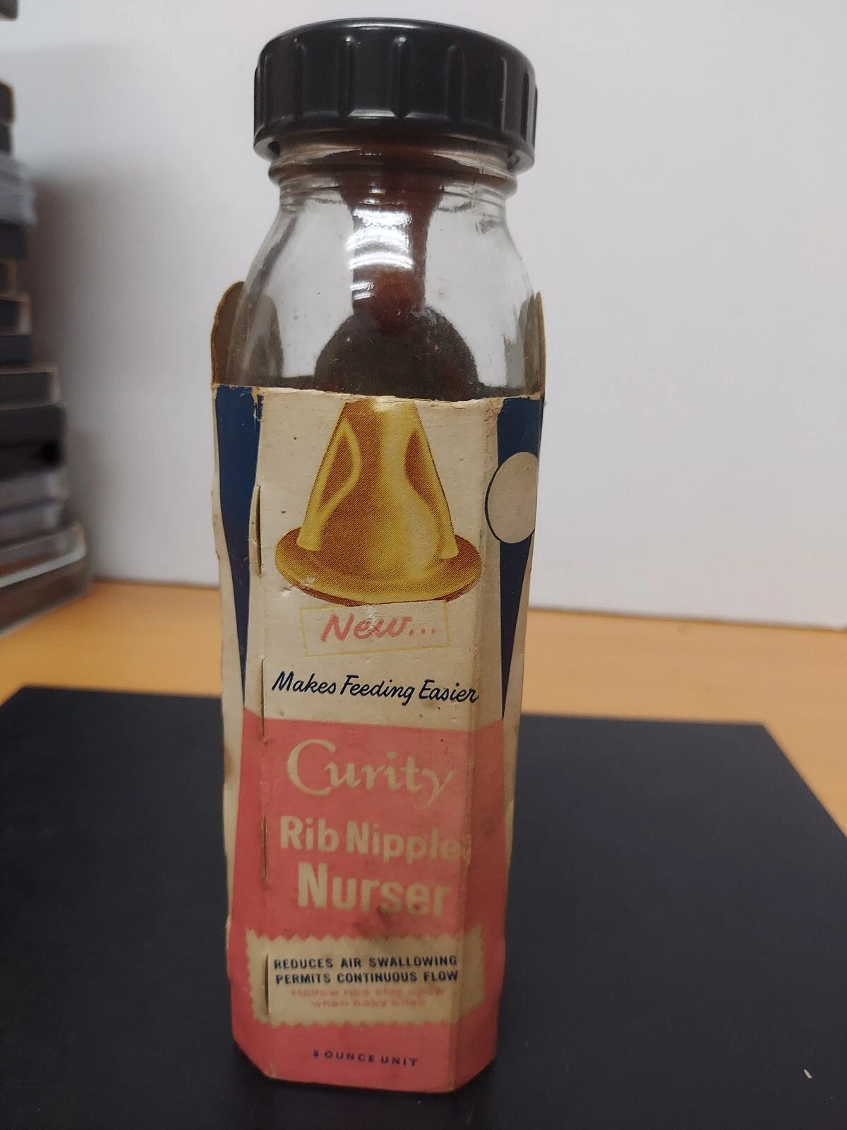 Vintage Curity “Rip Nipple” baby glass bottle with nipple and bottle sleeve